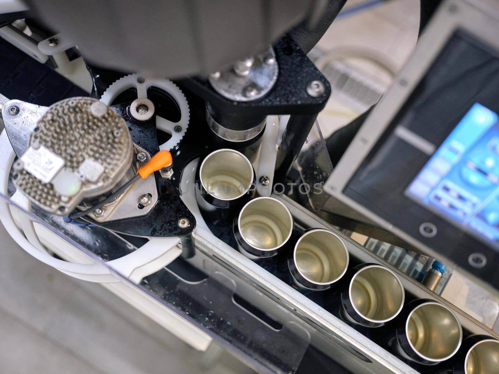 Top view of a raw of cans in a production line of a canning factory by WesternExoticStockers