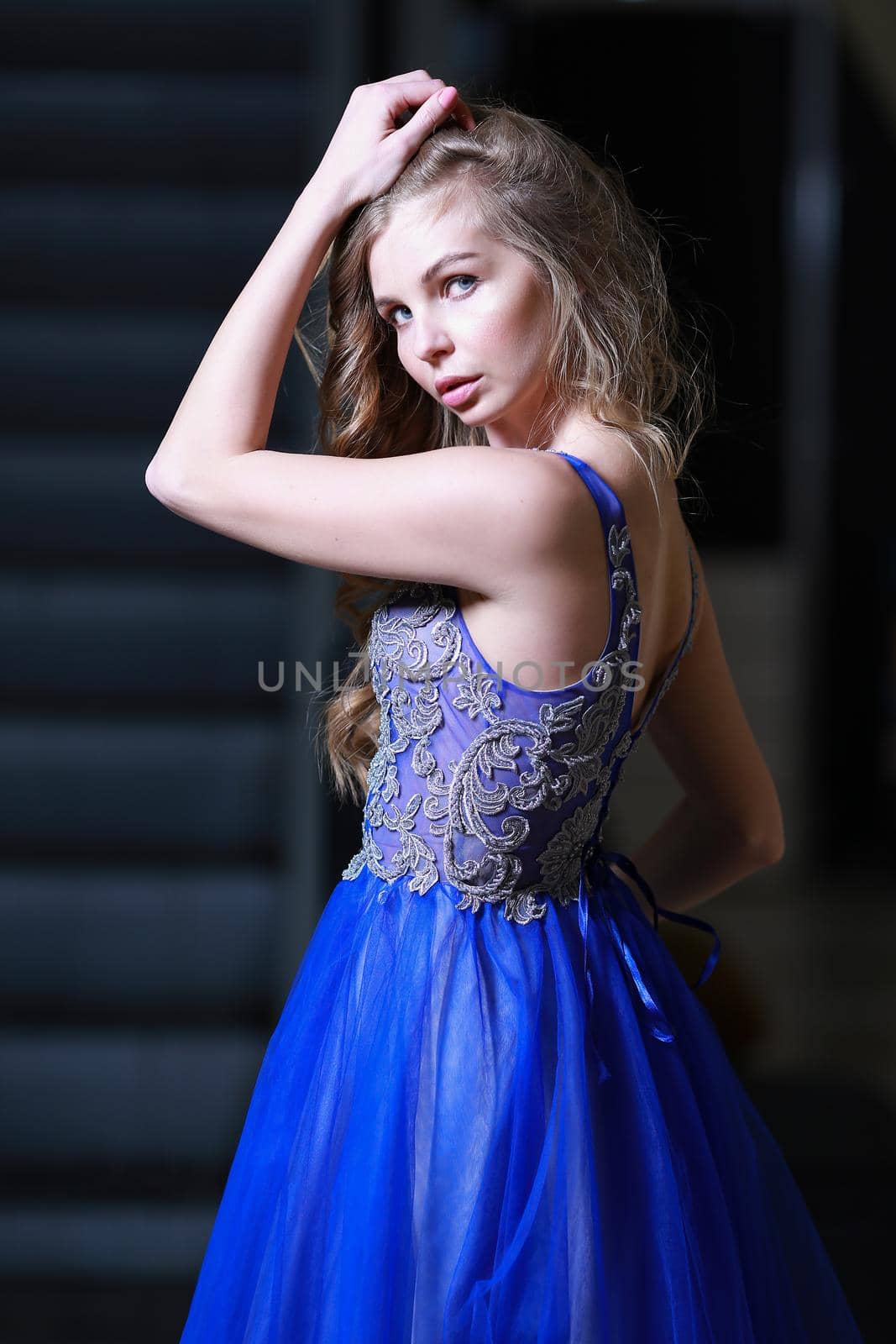 Elegant girl in fluttering blue dress