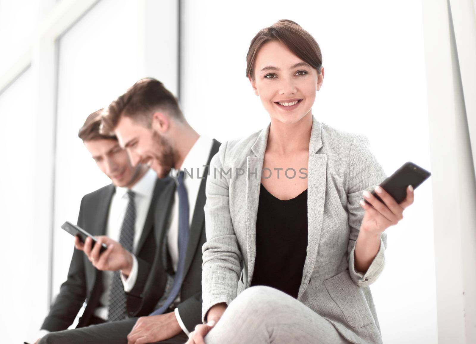 young business woman sitting in office lobby during work break. by asdf