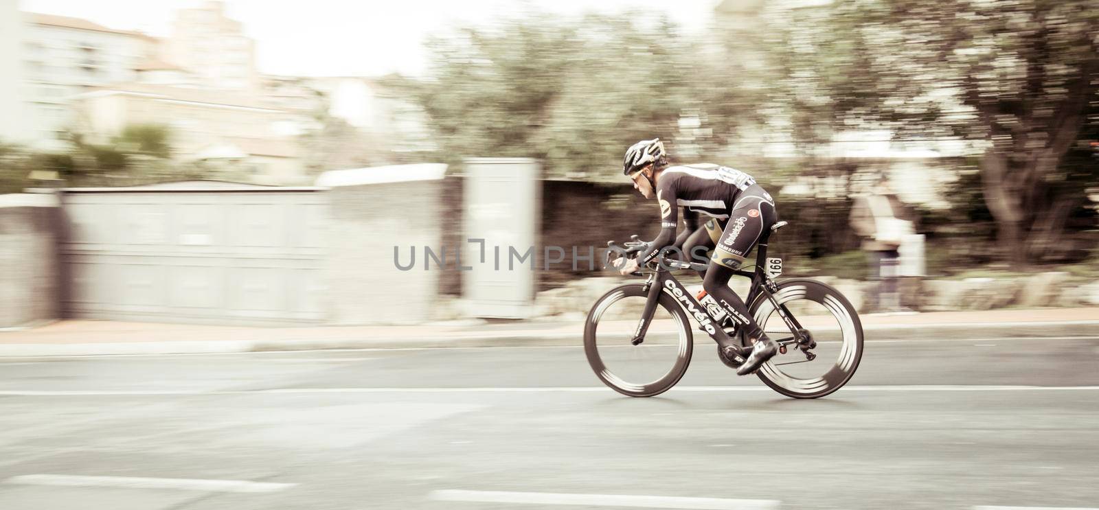 Imperia, IM, Liguria, Italy - March 23, 2015: An important cycling race in a small town in Italy in March. The name of the competition is Milano-Sanremo 2015, The cyclist is photographed during a burst of speed.