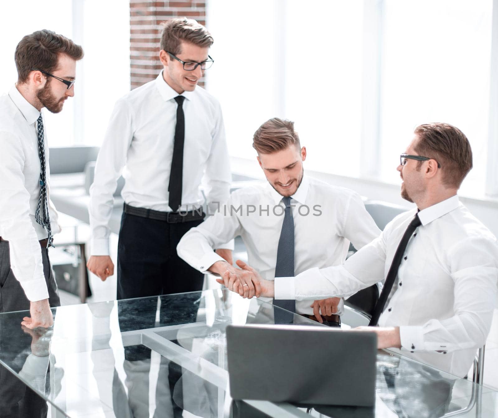 friendly handshake with colleagues behind a Desk.photo with copy space