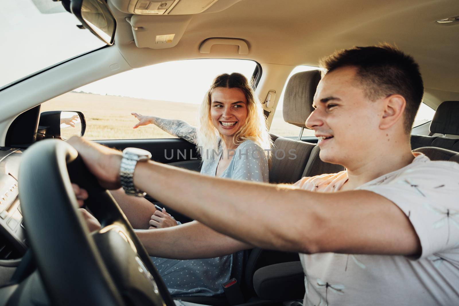 Happy Couple Enjoying Road Trip, Young Woman and Man Having Fun Time While Traveling by Car