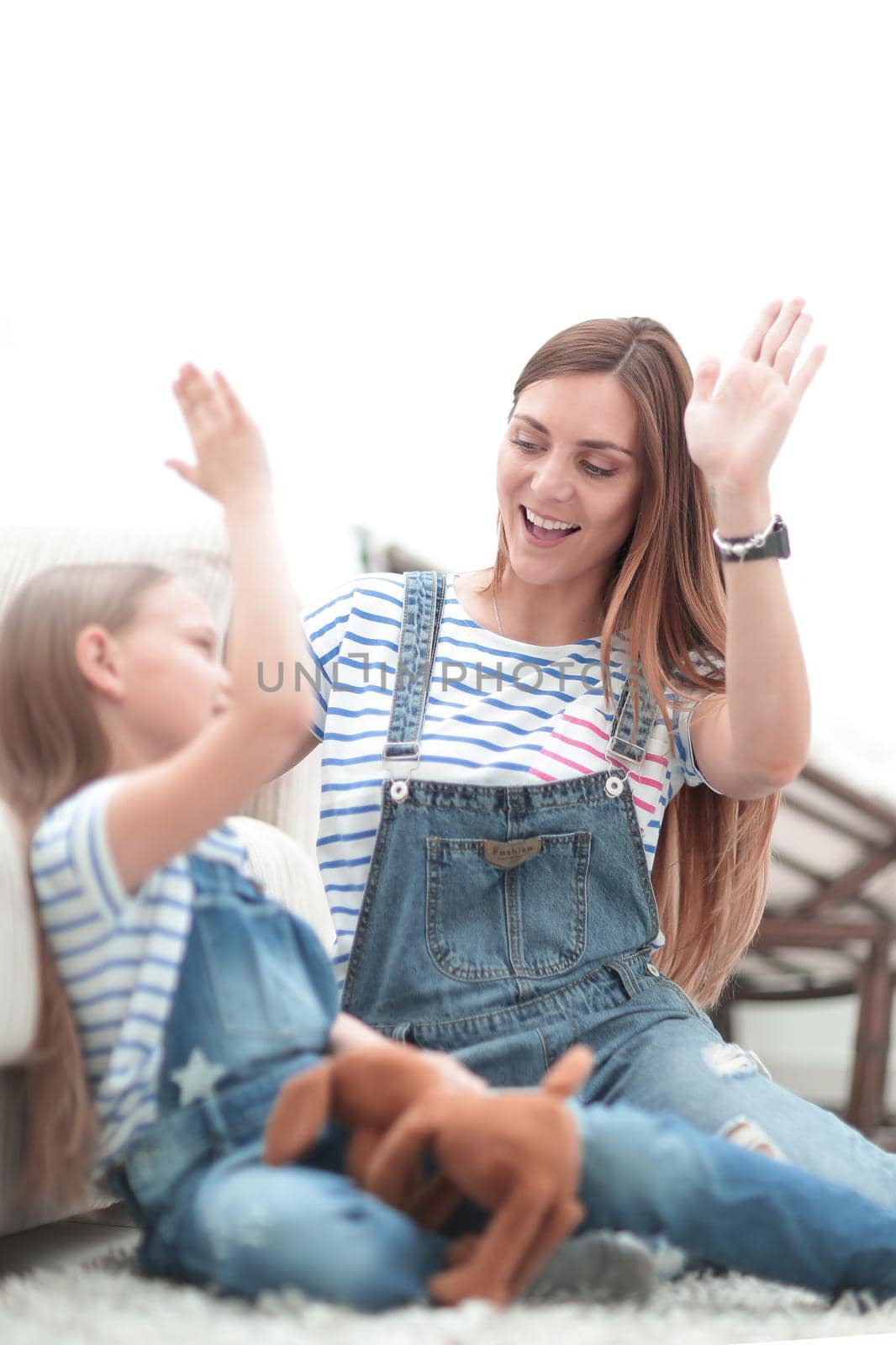 mother and her little daughter give each other a high five.photo with copy space