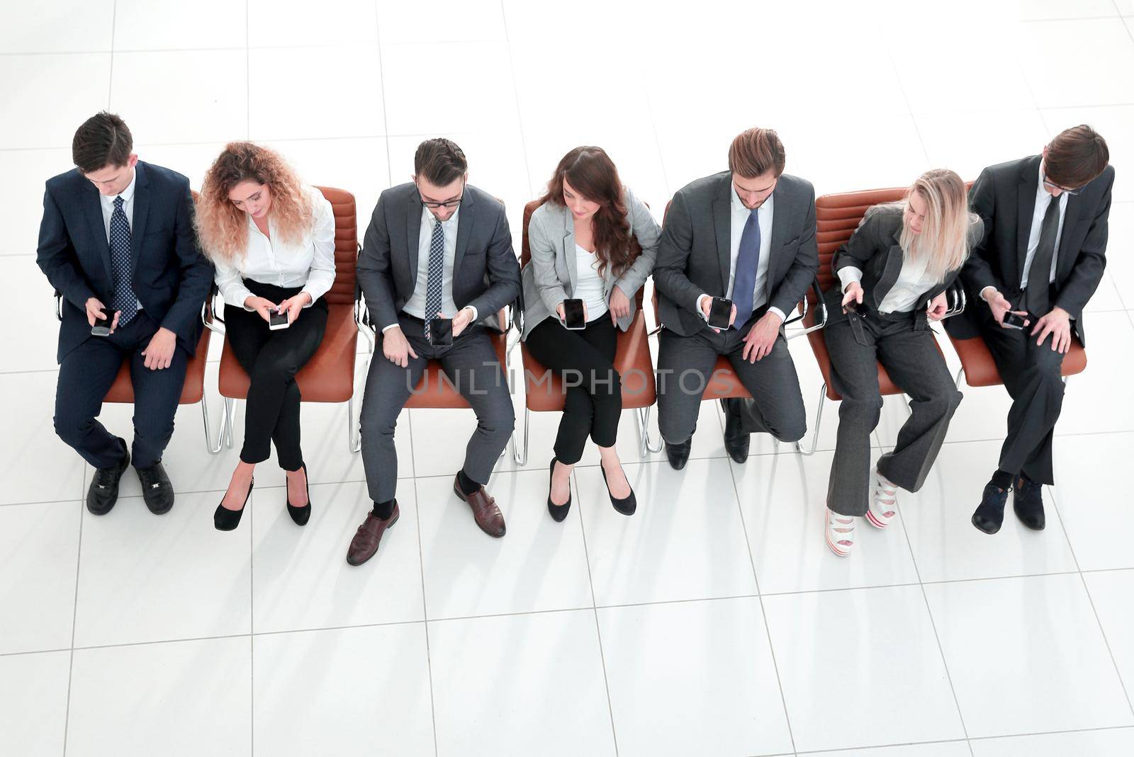 modern business team using their smart phones.isolated on a white background.