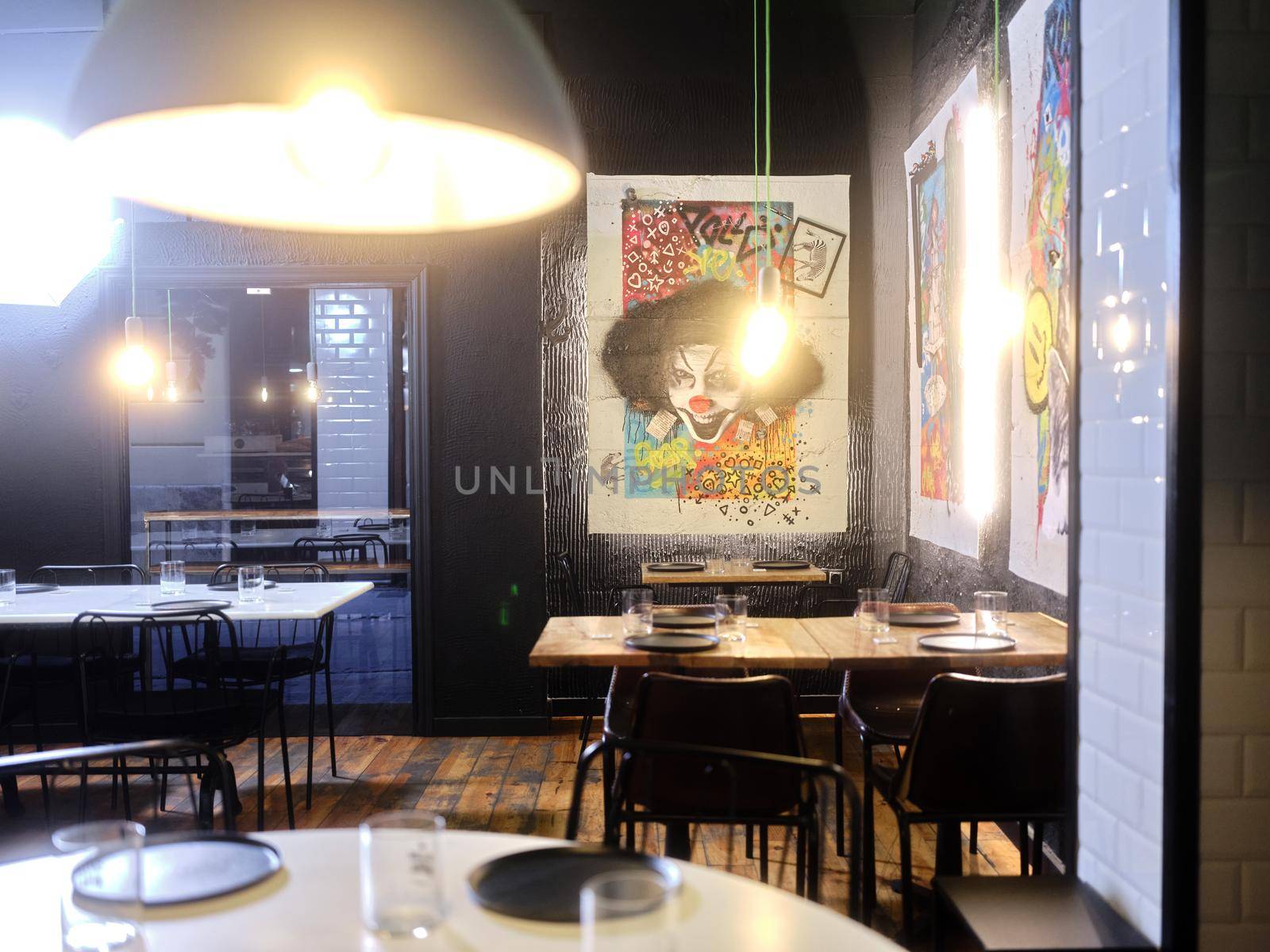 Restaurant decorated with modern art paintings without people inside