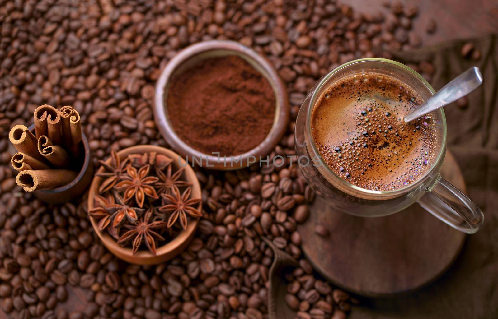 Hot black coffee and coffee beans on the old wooden table by aprilphoto