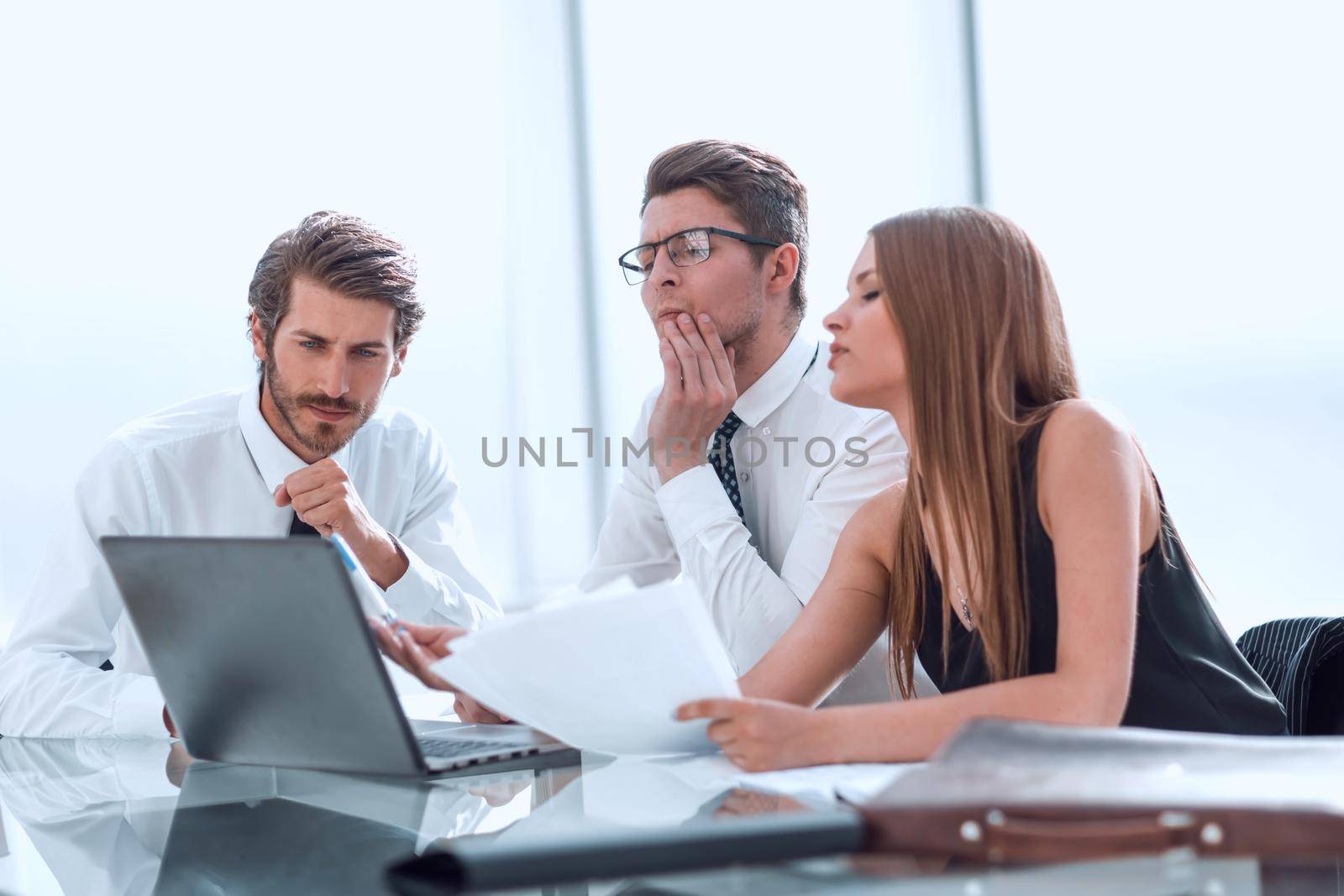 business team looking closely at the laptop screen. people and technology