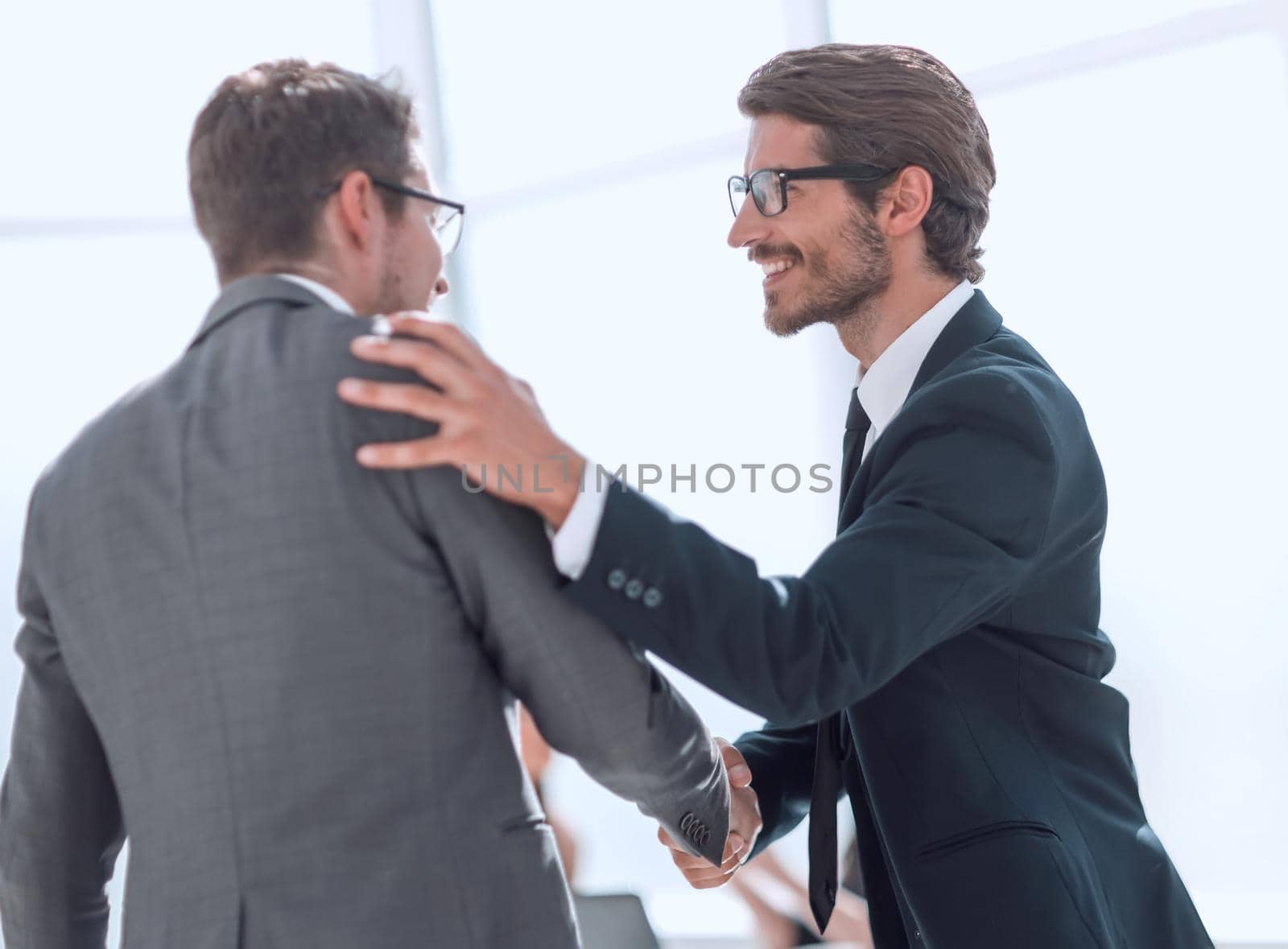 smiling business people greet each other with a handshake. concept of cooperation