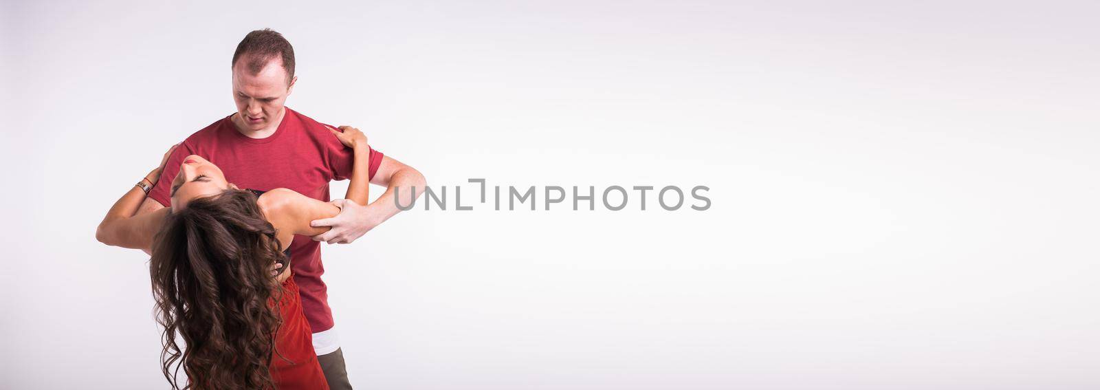 Dancers couple dancing social latin dance bachata kizomba salsa - social dance. Two elegance pose on white background with copy space banner and place for advertising by Satura86