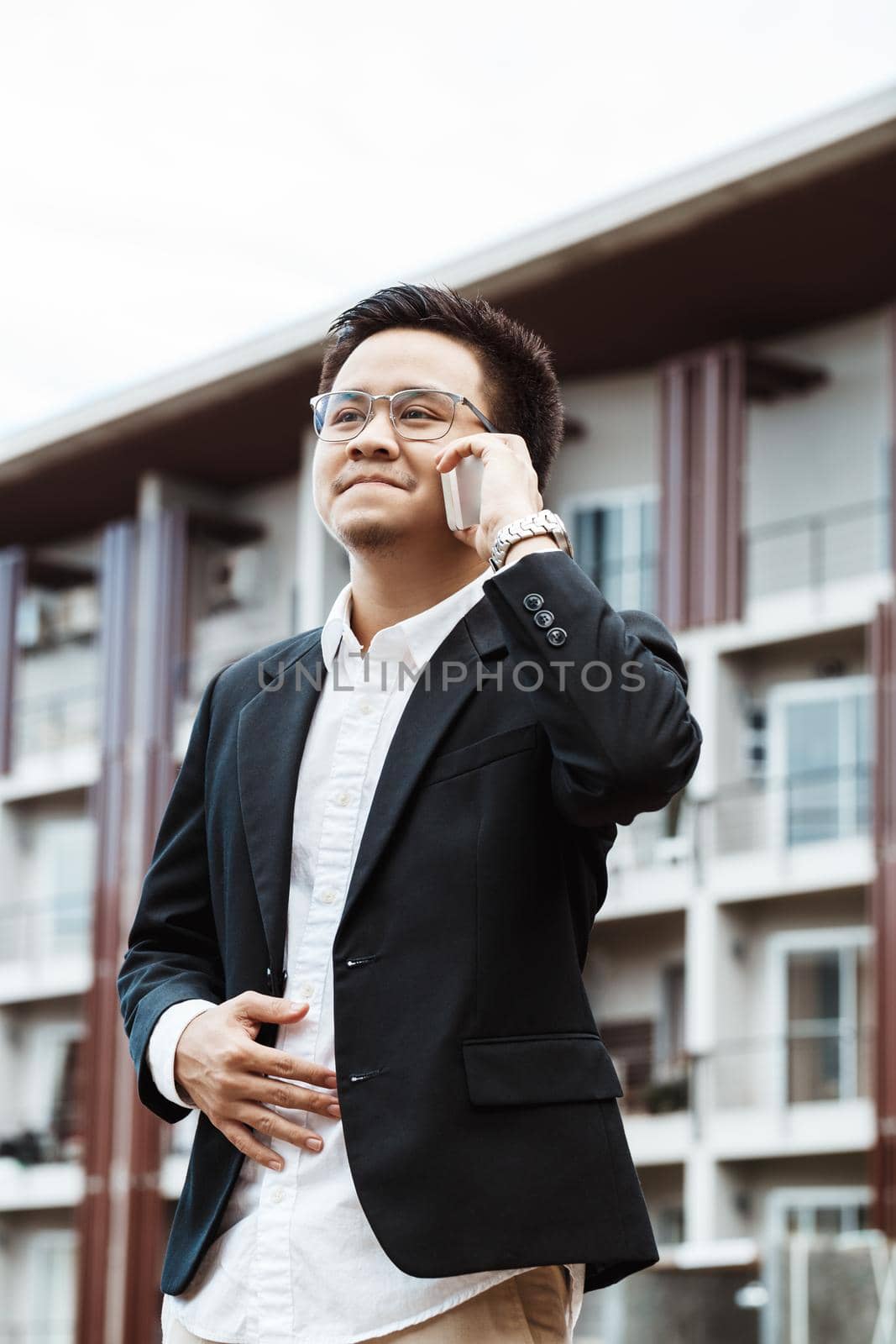 Concept Business - Business man serious talking with his project on his mobile phone