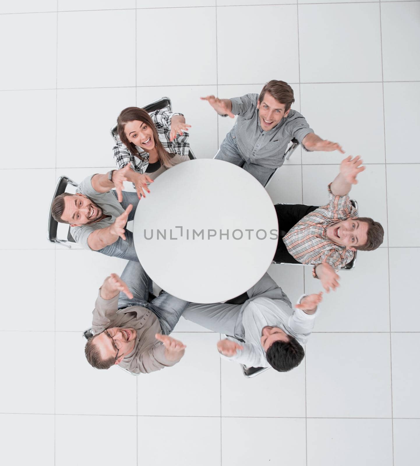 top view. business team holding up their hands and looking at the camera.photo with copy space