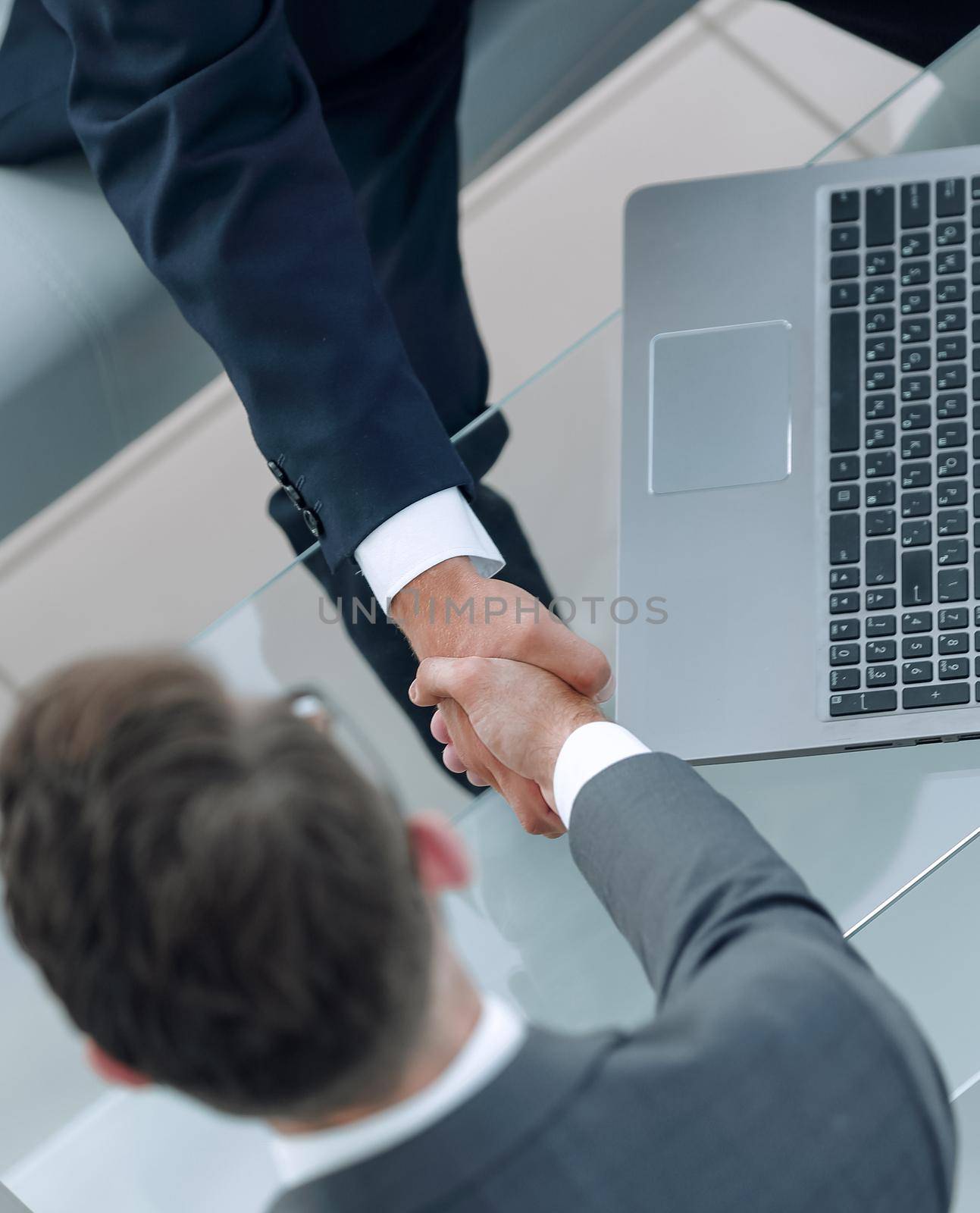 handshake business people in the workplace. by asdf
