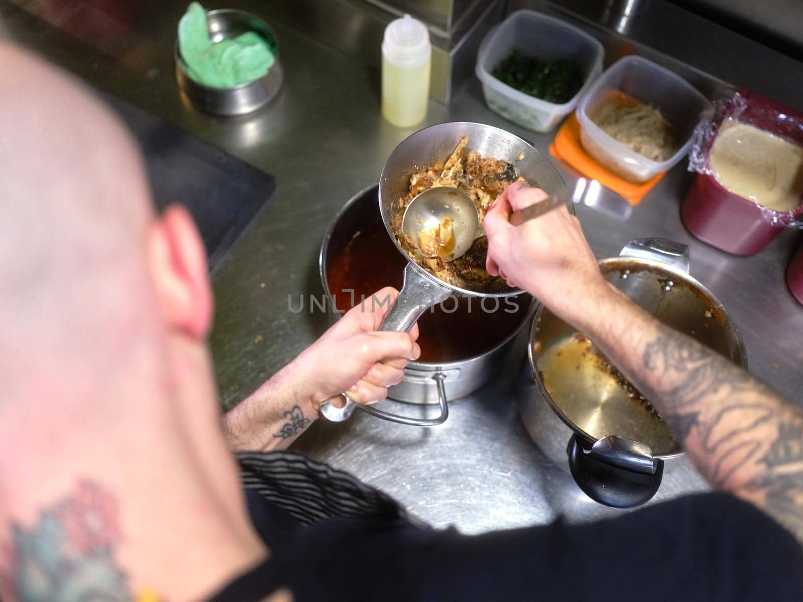 Chef pressing food into a colander to make some sauce by WesternExoticStockers