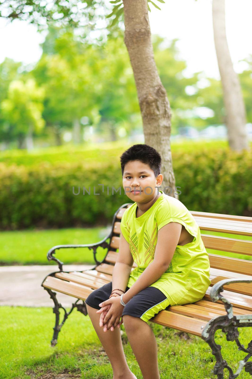 Asain cute little boy sitting with green nature by Benzoix
