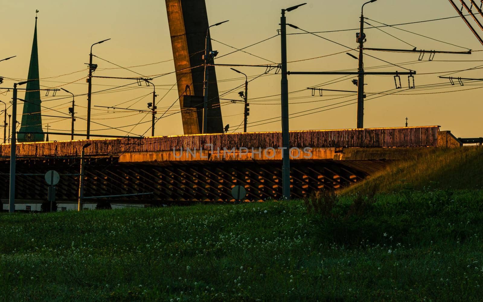 Riga, Latvia- July 17 2020: capital city bridge view at sunrise time, lanterns and electricity lines
