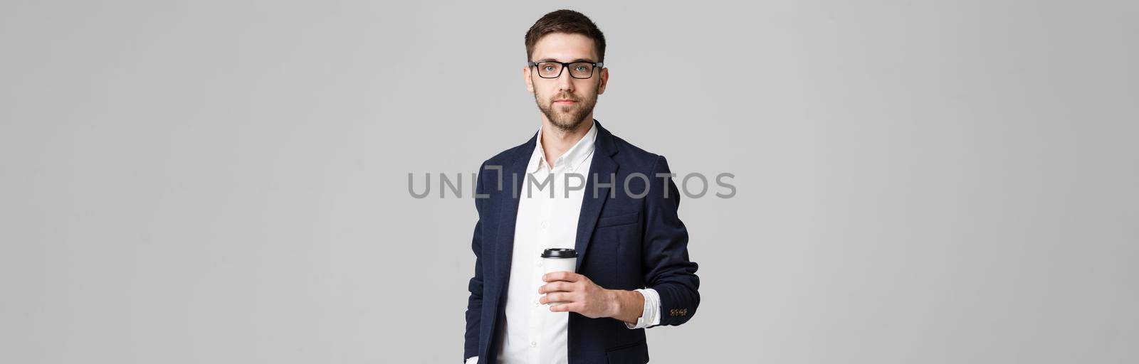 Portrait of a handsome businessman in eyeglasses with a cup of coffee.