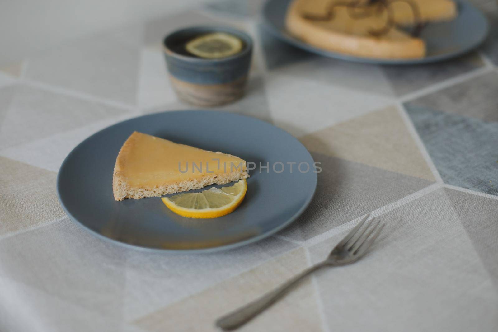 Closeup of yummy lemon tart with tea set and lemons
