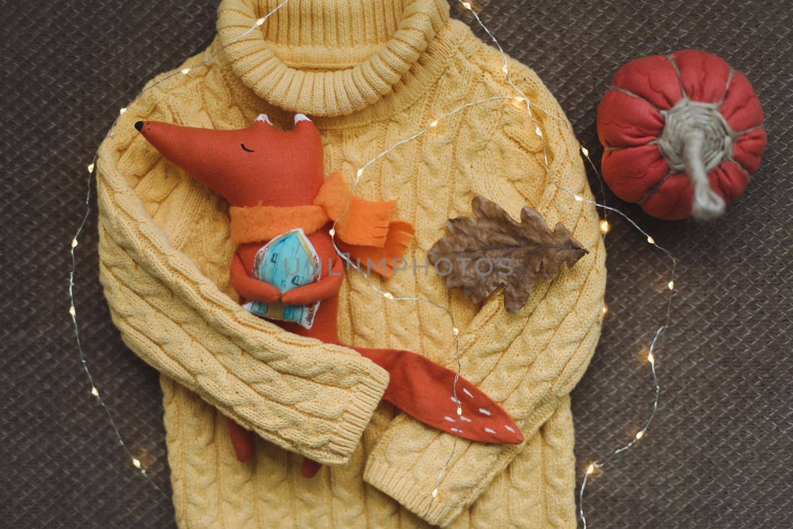 cozy autumn composition with a funny handmade toy fox