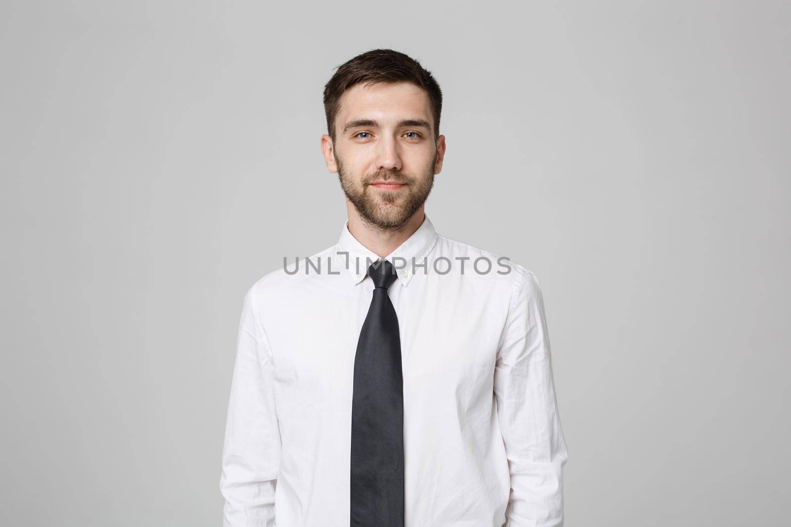 Business Concept - Young successful businessman posing over dark background. Copy space. by Benzoix