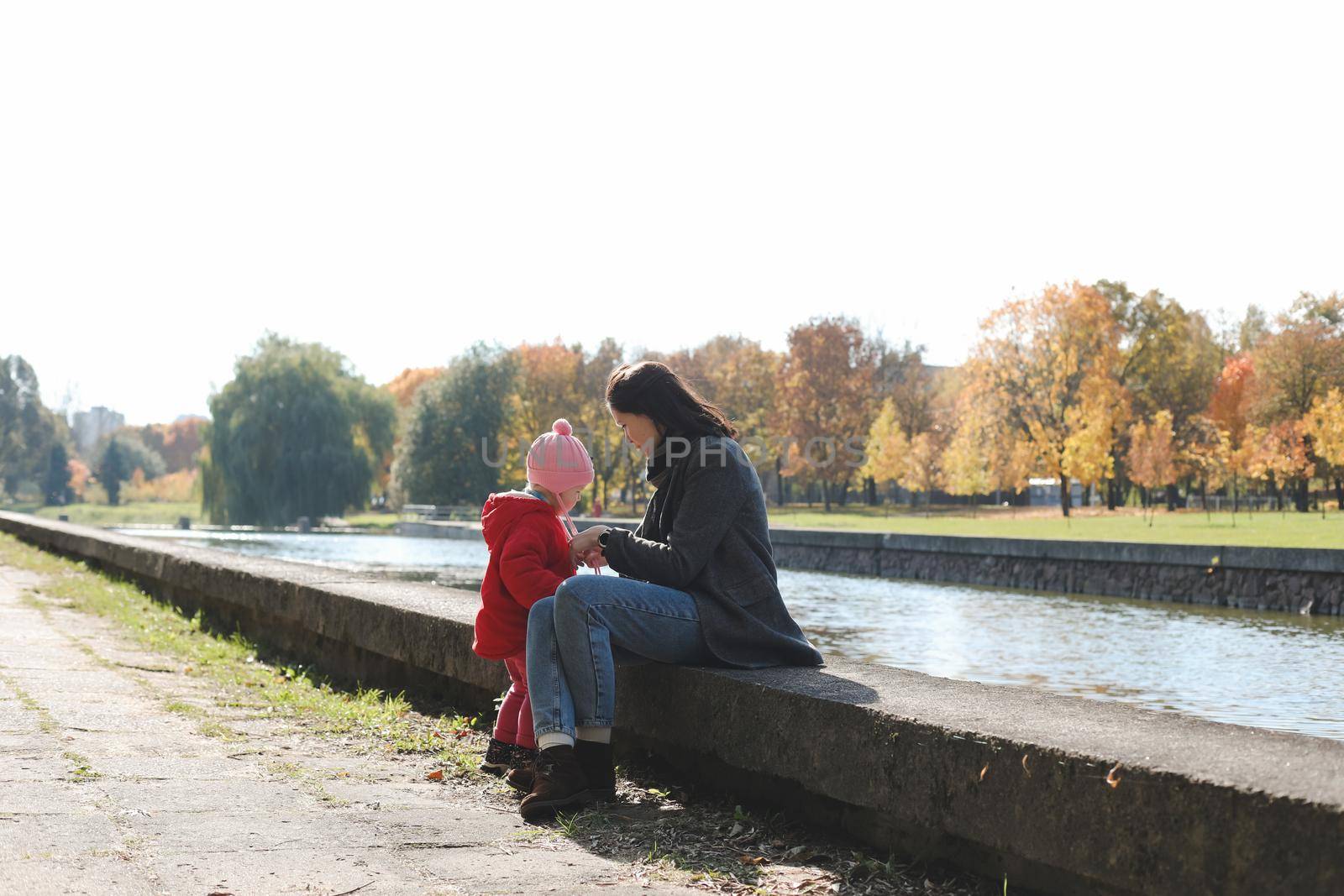 mom and child having fun and walking in the autumn park.