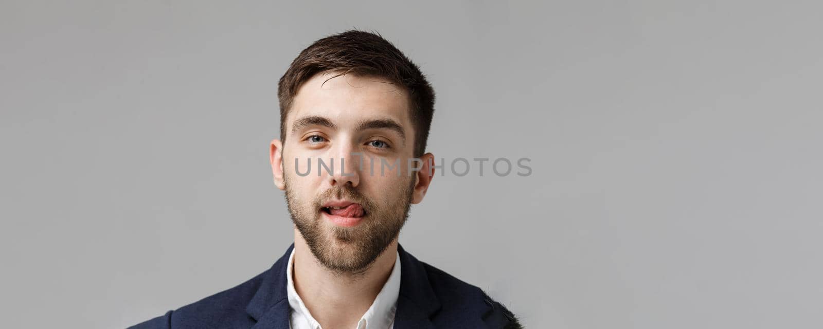 Business Concept - Portrait handsome happy handsome business man in suit smiling and siting in work office. White Background. by Benzoix