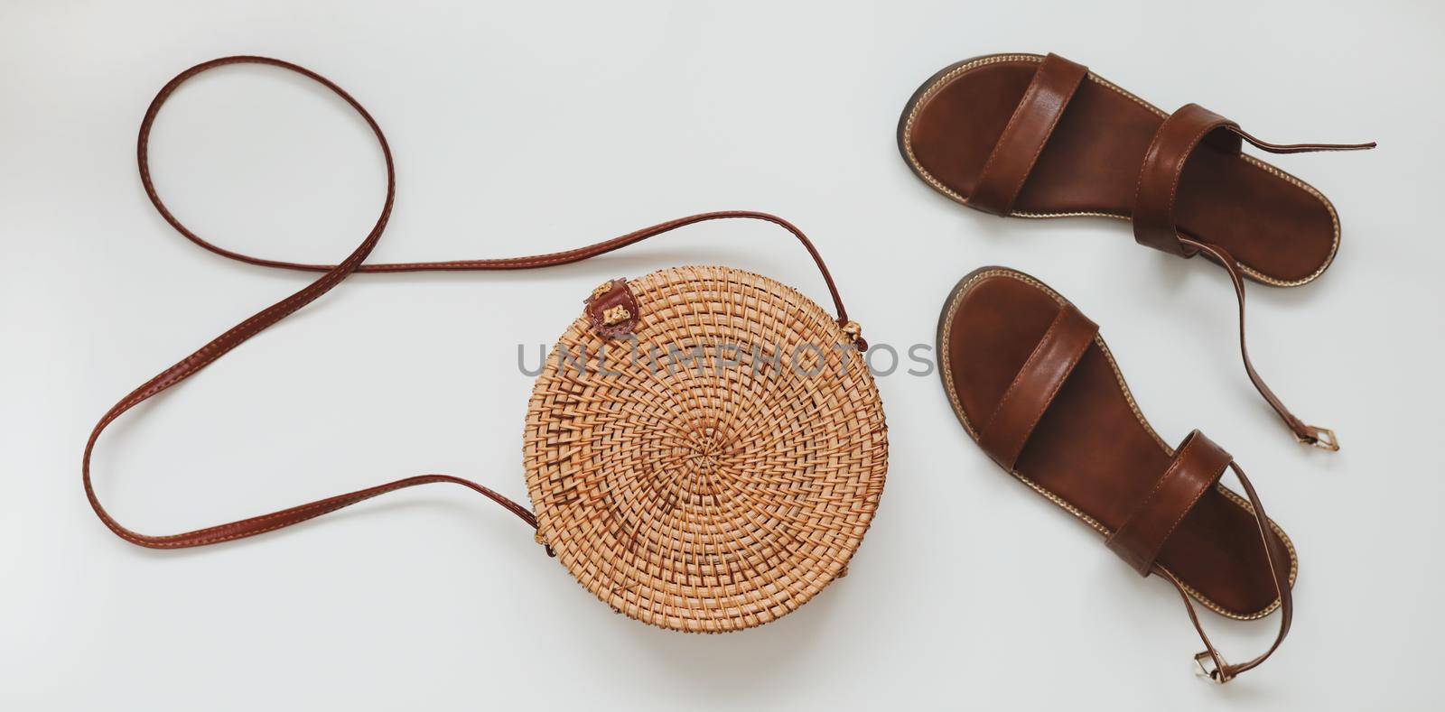 Top view of female sandals and a wicker rattan bag. summer concept