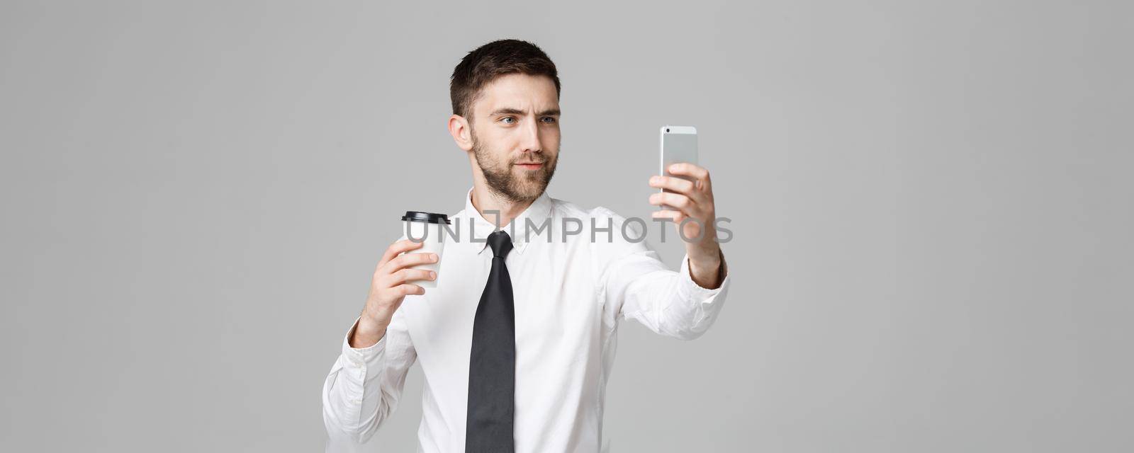 Lifestyle and Business Concept - Portrait of a handsome businessman enjoy taking a selfie with take away cup of coffee. Isolated White background. Copy Space. by Benzoix