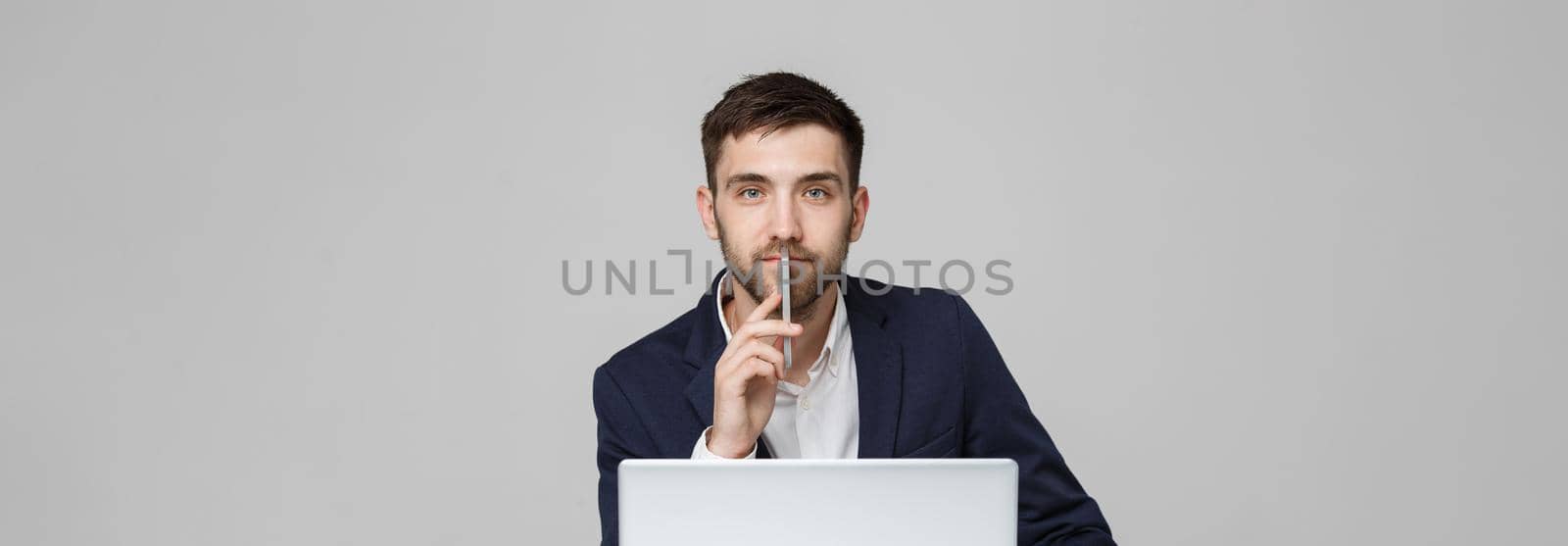 Business Concept - Portrait handsome happy handsome business man in suit playing moblie phone and smiling with laptop at work office. White Background. by Benzoix