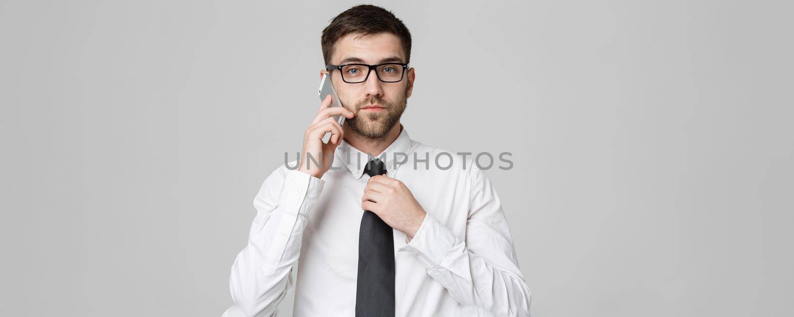 Lifestyle and Business Concept - Portrait of a handsome businessman serious talking with mobile phone. Isolated White background. Copy Space.