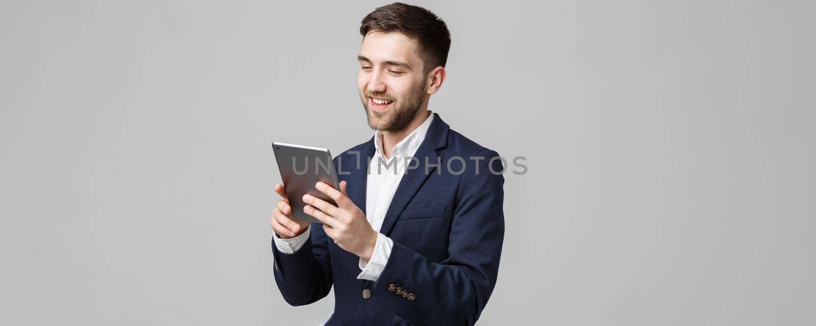 Business Concept - Portrait Handsome Business man playing digital tablet with smiling confident face. White Background. Copy Space. by Benzoix