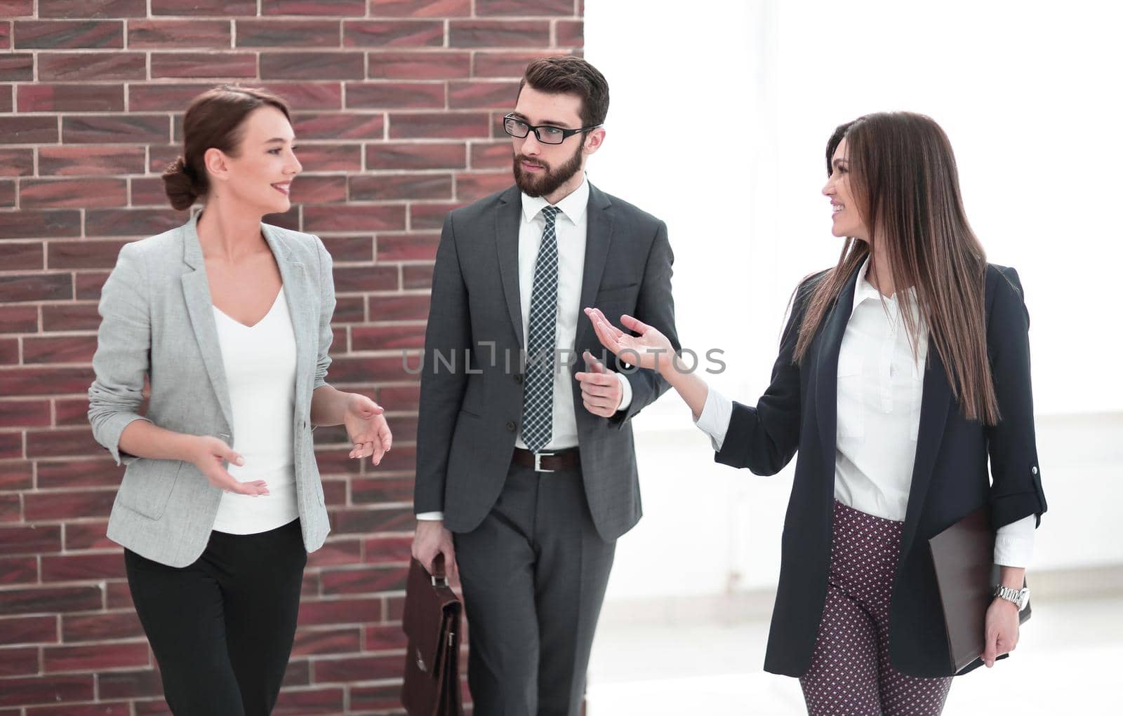 business woman talking to colleagues standing in the office.photo with copy space