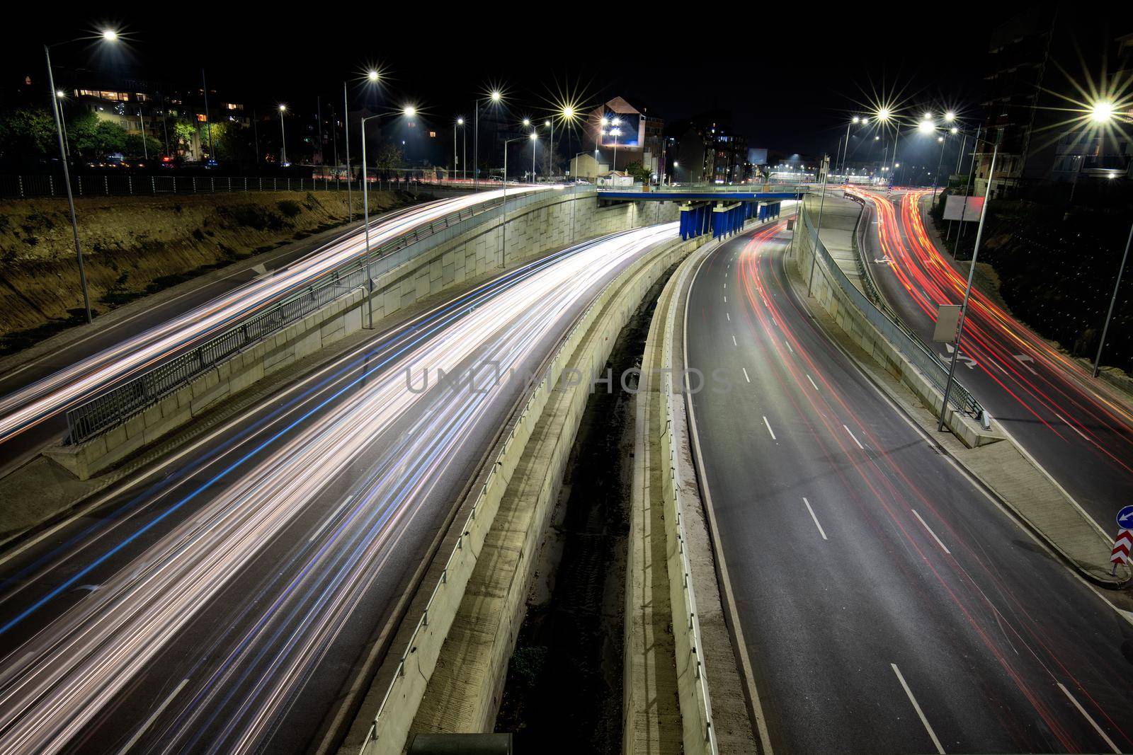 Night traffic junction road with lights of vehicle movement. Horizontal view