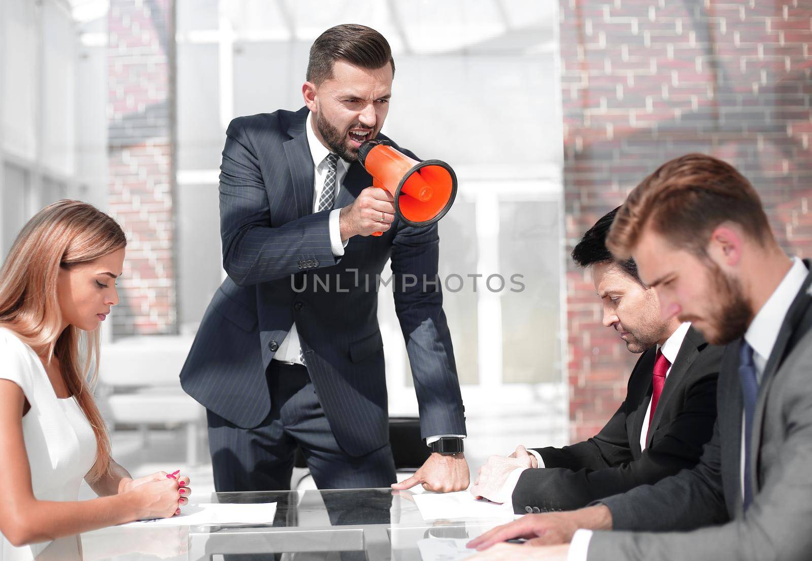 businessman uses a megaphone to talk to a business team. management concept