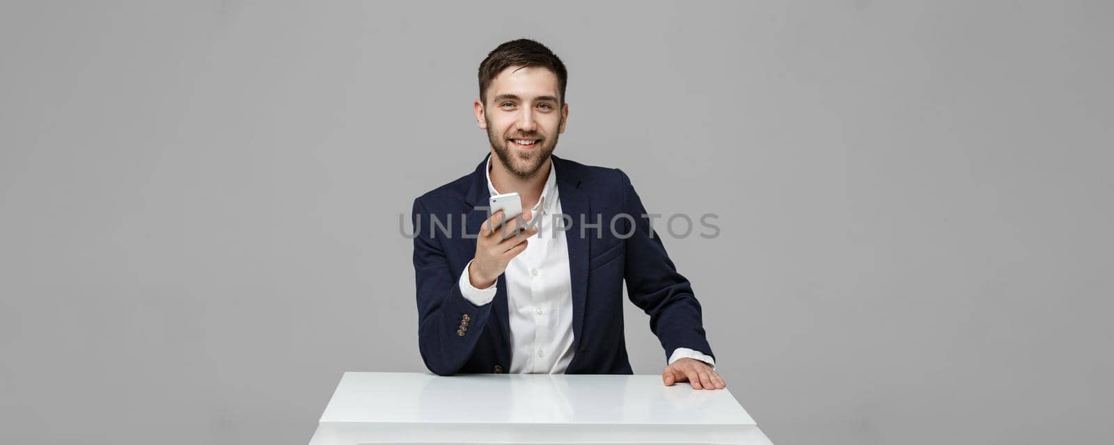 Business Concept - Portrait Handsome Business man playing phone with smiling confident face. White Background.Copy Space.