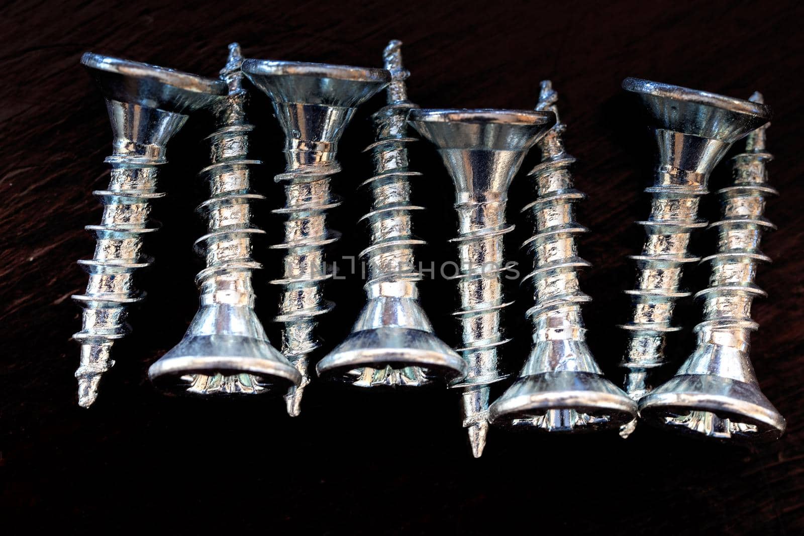 Top view of screws on a black background.