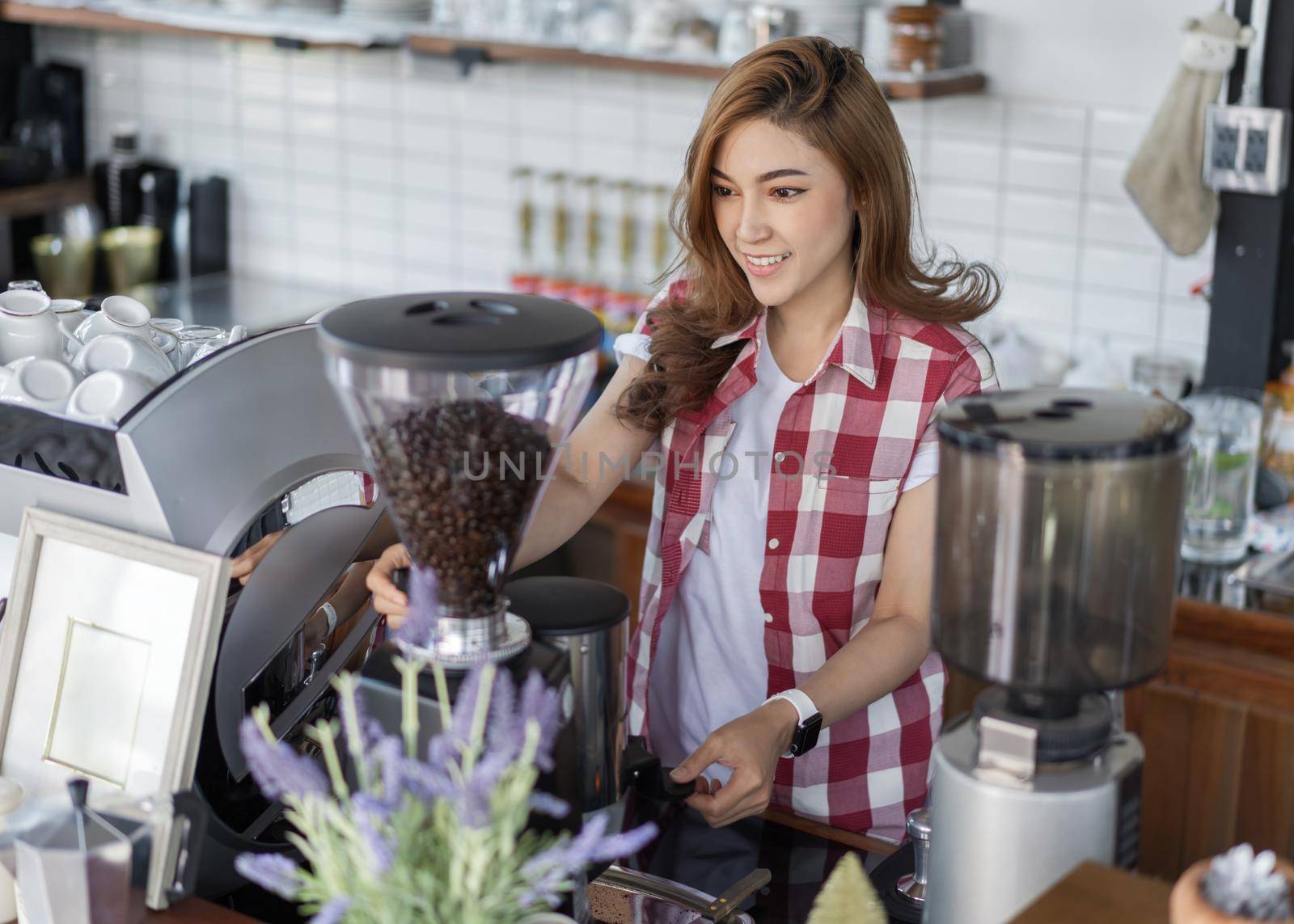 woman preparing coffee with machine in a cafe