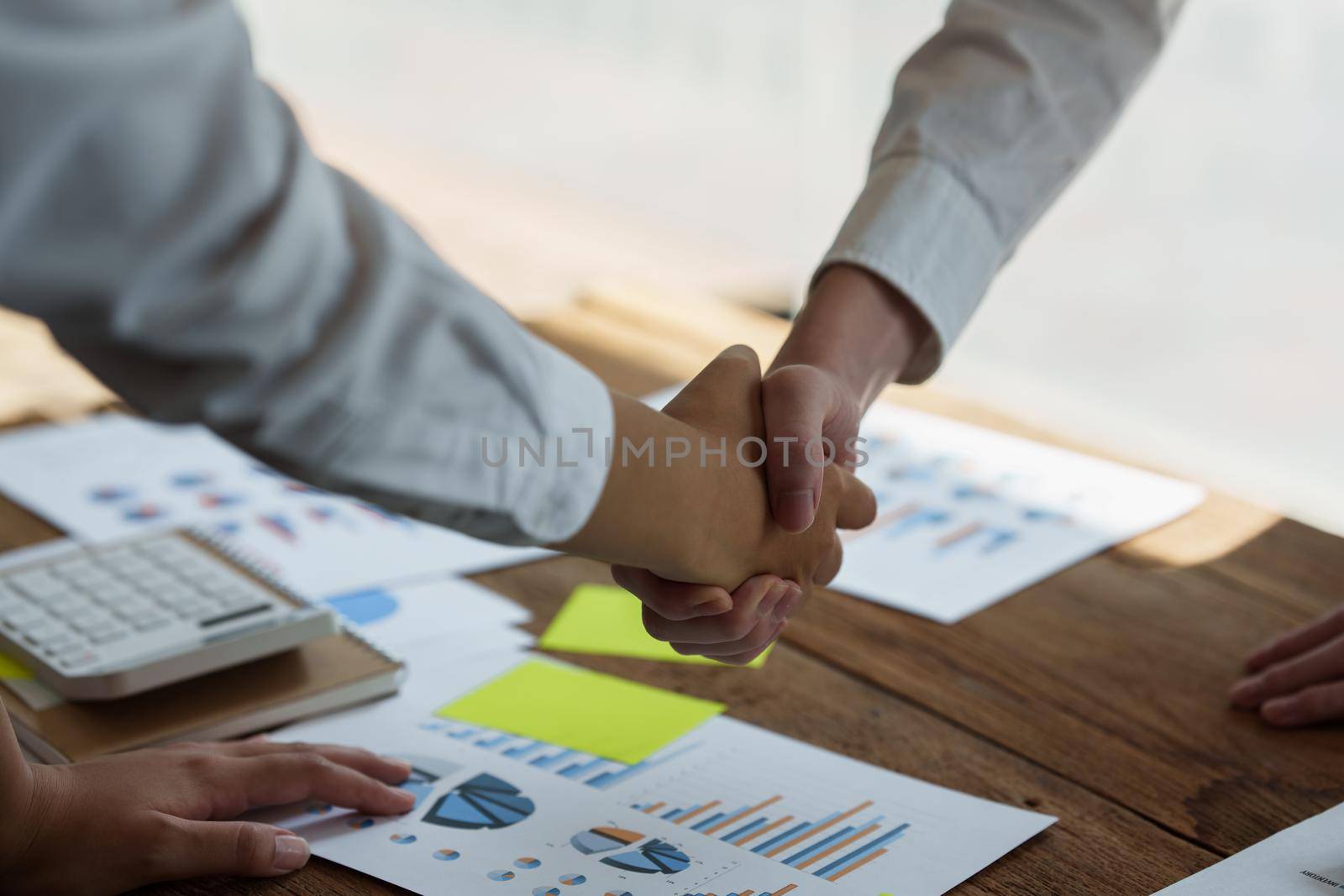 Business partnership meeting concept. Image businessman handshake. Successful businessmen handshaking after good deal. Group support concept. by itchaznong