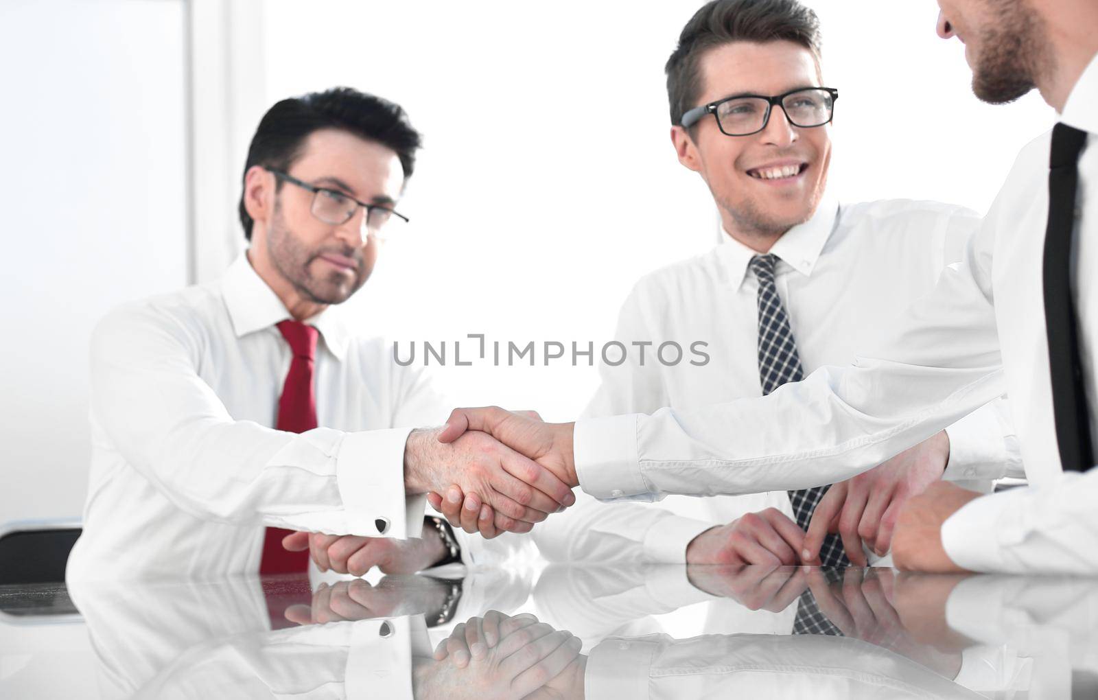 employees greet each other with a handshake. by asdf