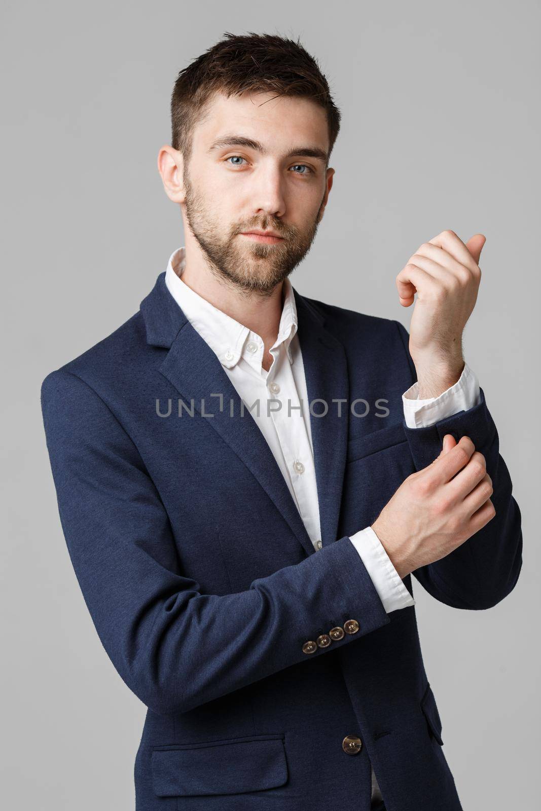 Business Concept - Young successful businessman posing over dark background. Isolated White Background. Copy space. by Benzoix