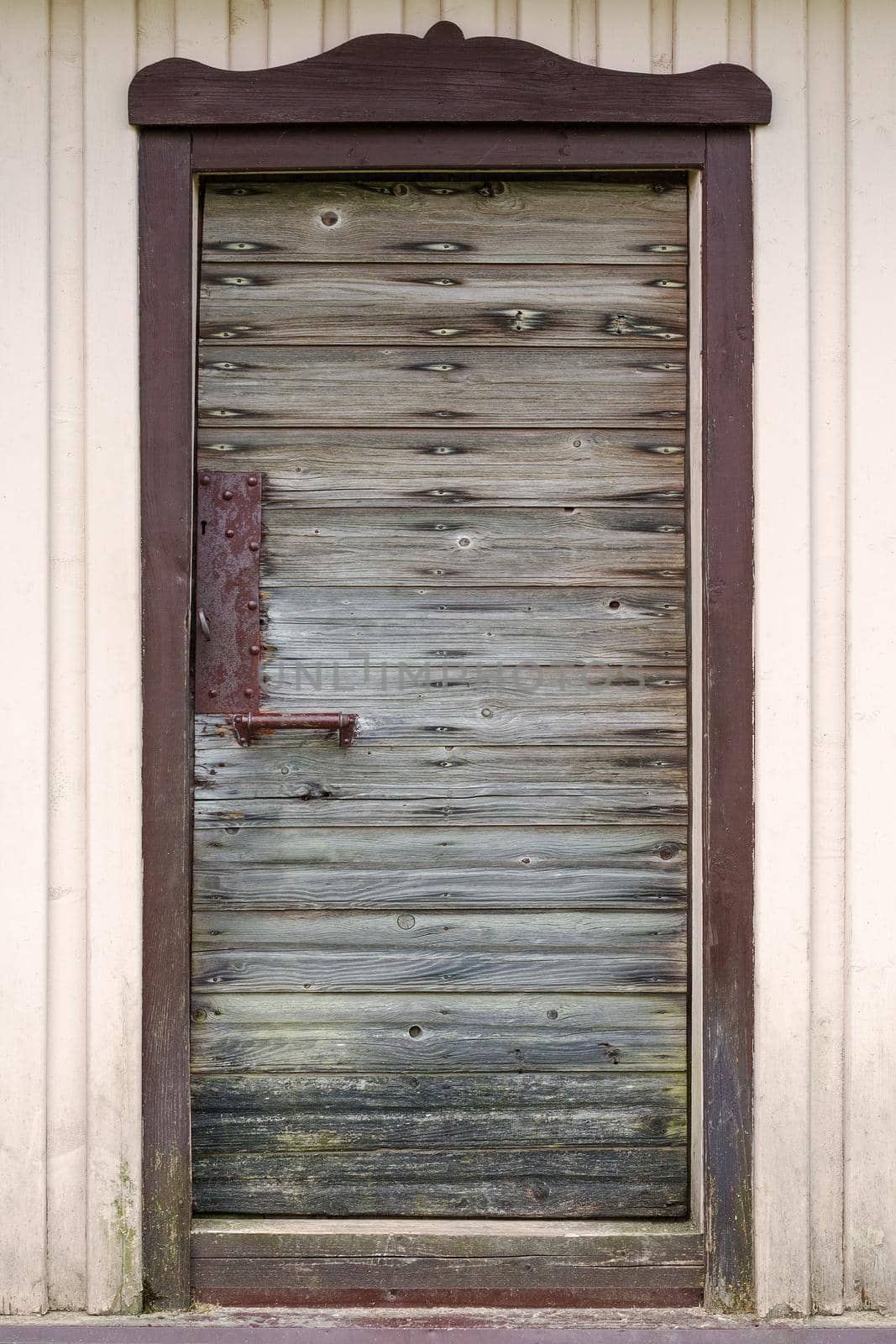 Old wooden door with metal handle, lock and old rusted planks. by Lincikas