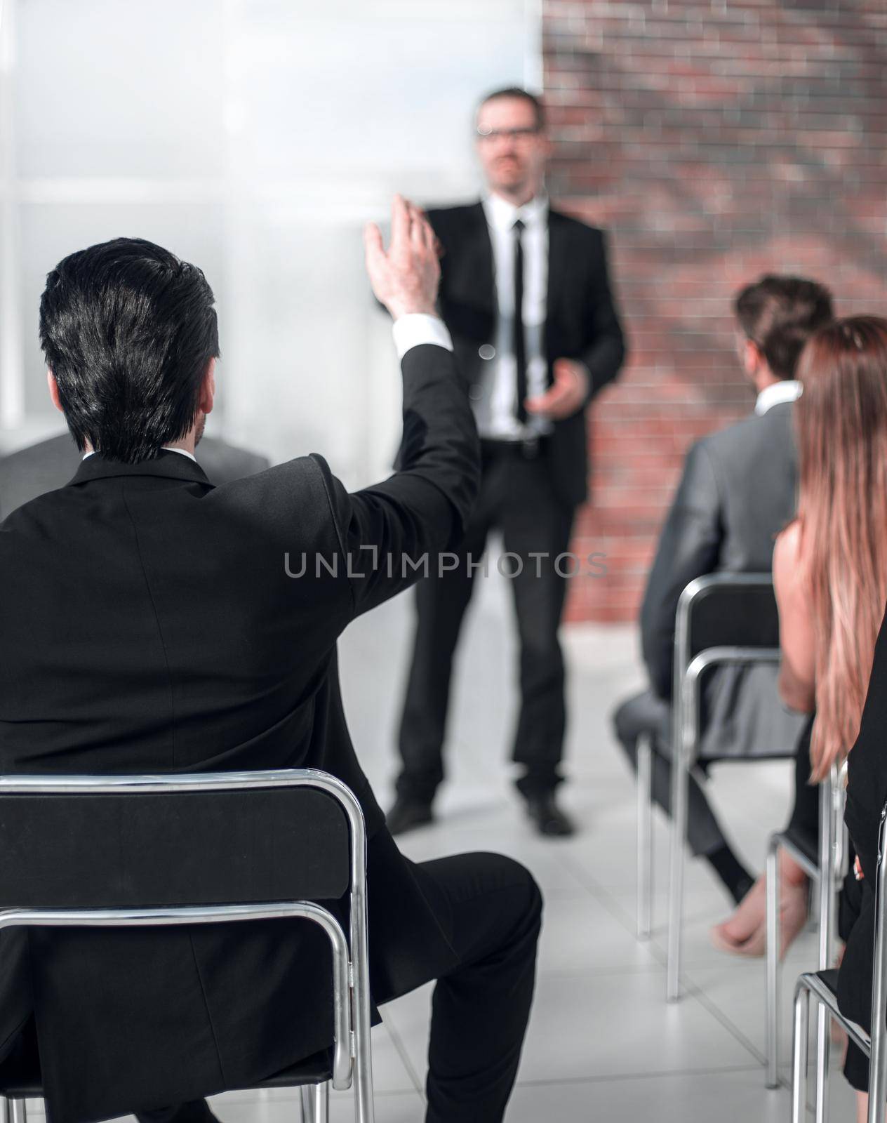 businessman answering questions from employees at a business meeting.business and education