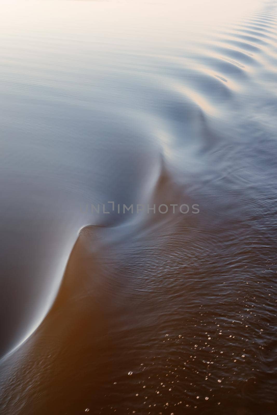 Footprint of the ship. Water twisted by a boat propeller. Beautiful water surface texture. by Lincikas