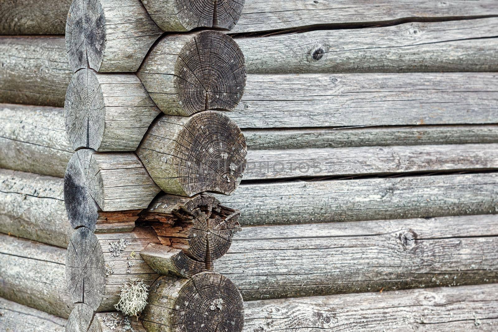 Close up on a old timber beam. Beautiful wooden pattern and with some lichens. On an old farmhouse on the countryside