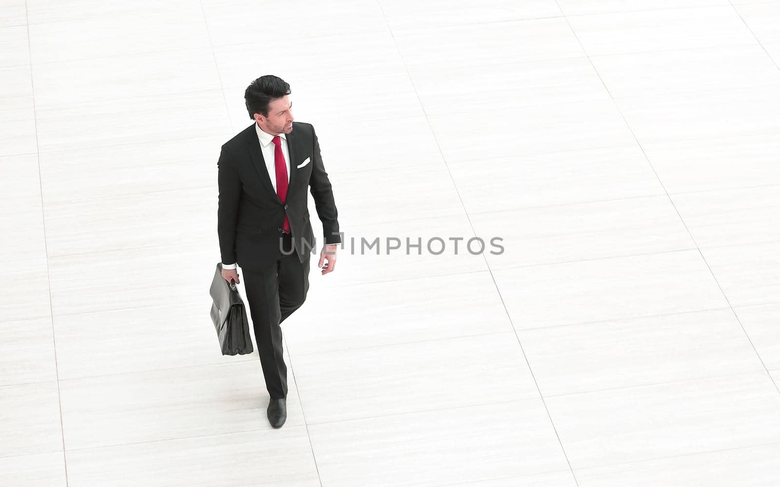 far away.business man with leather briefcase is coming . photo with copy space