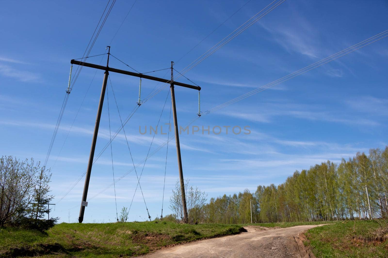 Transmission tower, or power line, in front of a clear blue sky, on a Sunny day