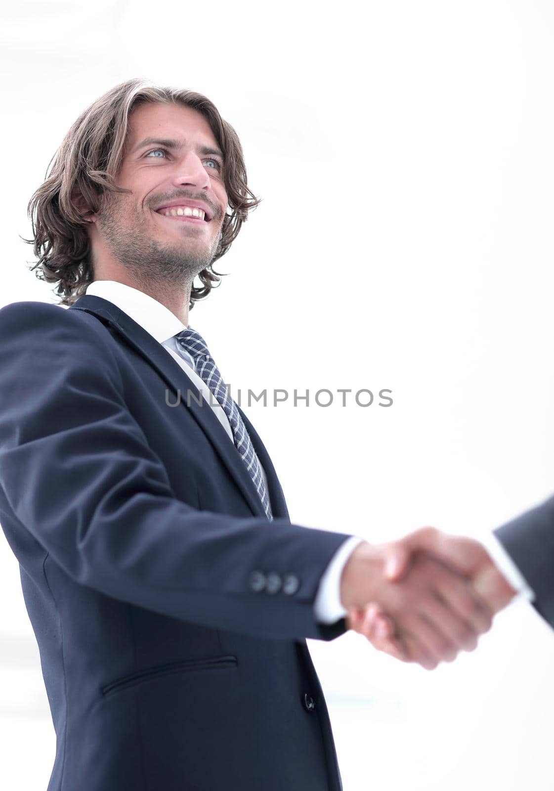 Digital composite of Midsection of business professionals shaking hands