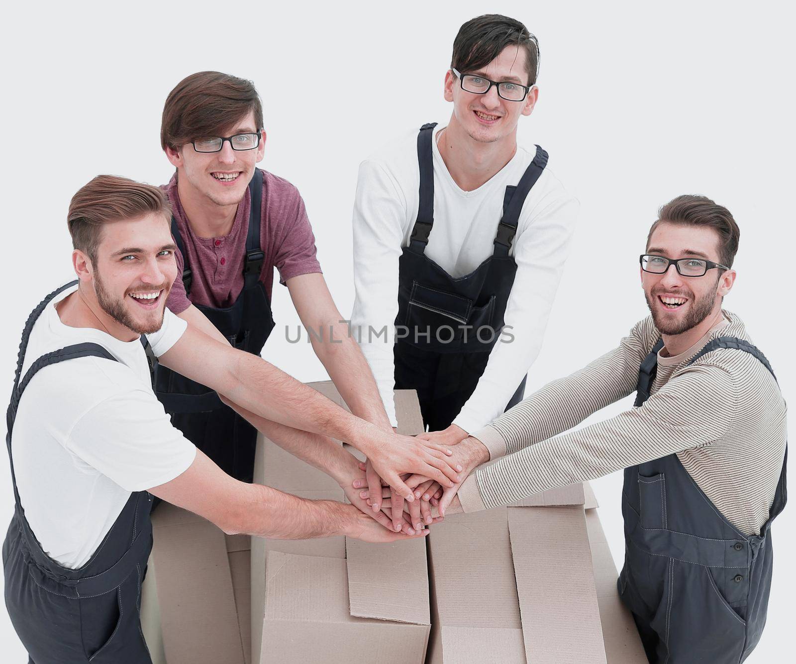 Cheerful movers leaning on stack of boxes isolated on white back by asdf