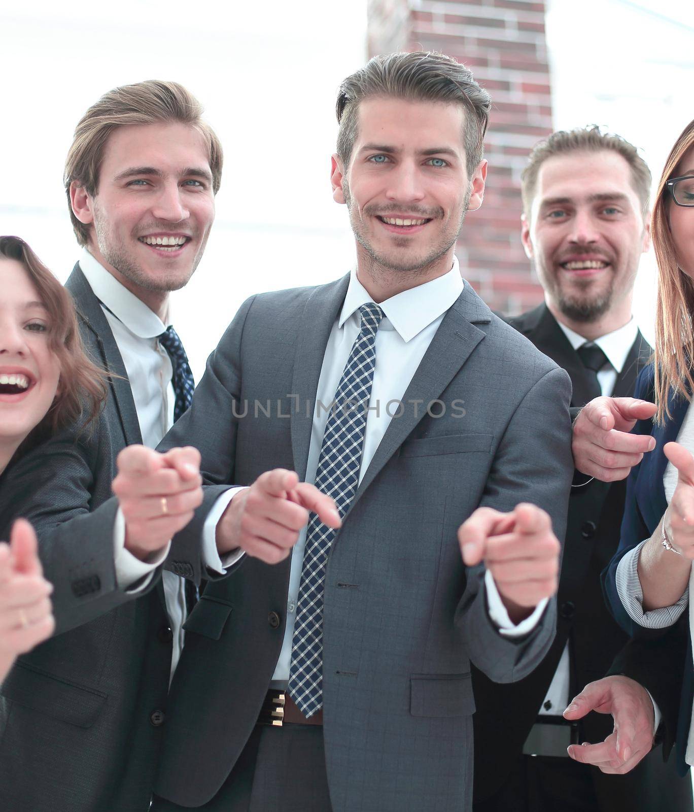 Business team is using putting fingers together and smiling while working in office