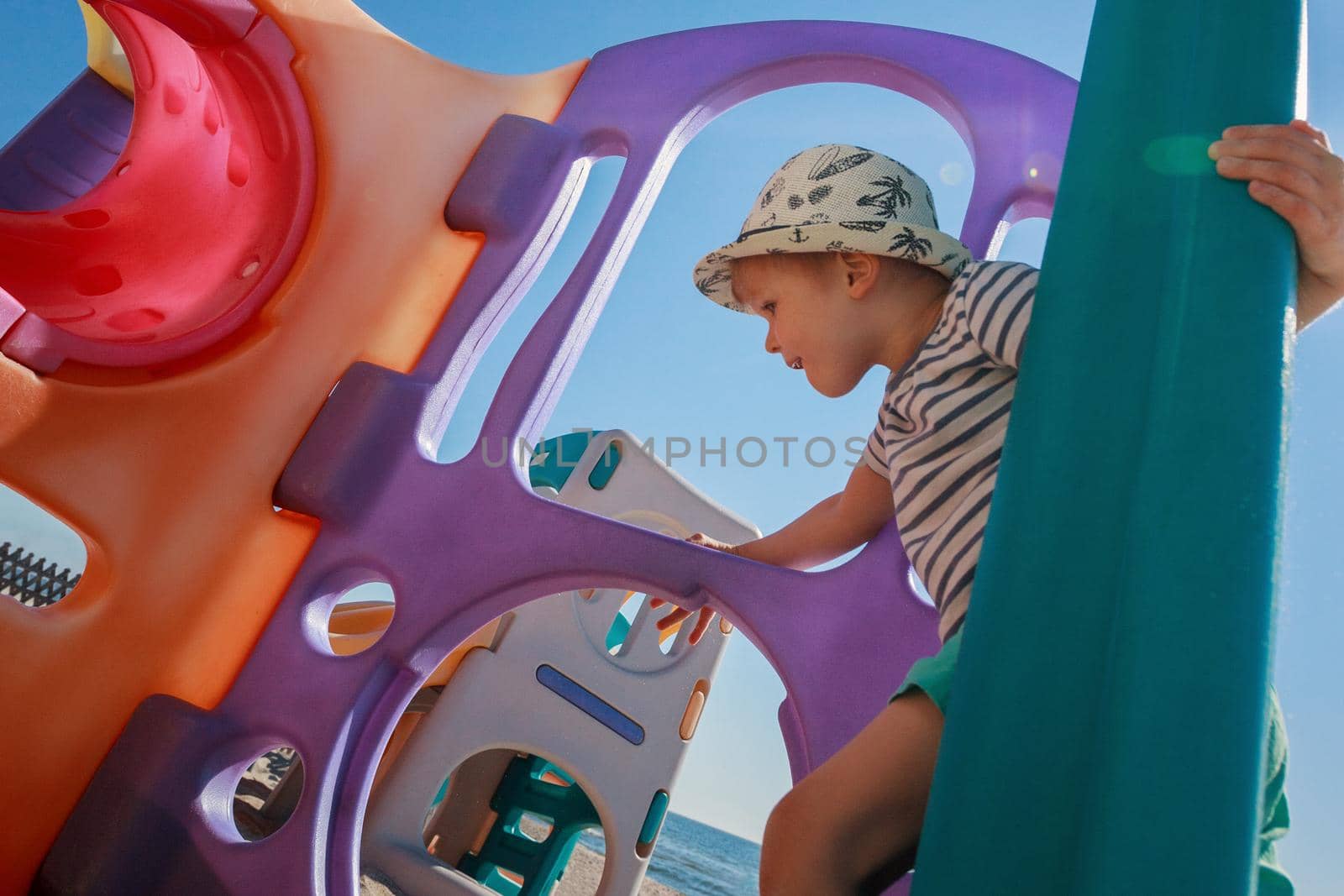Child playing in a colored maze playground