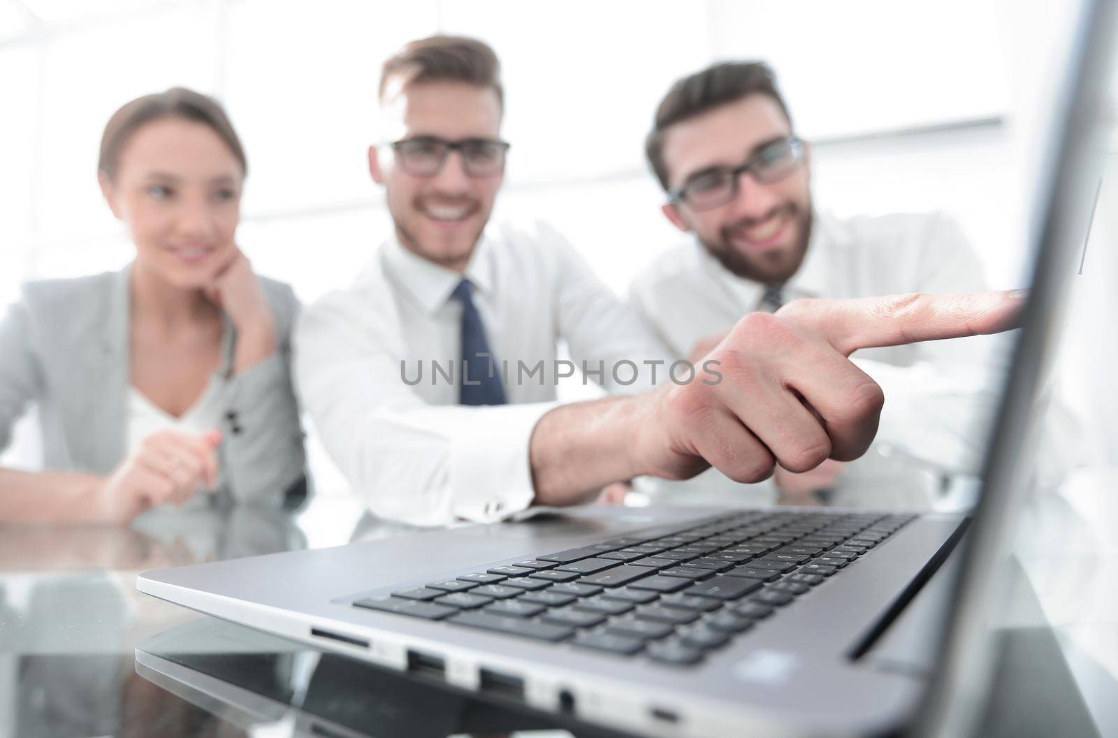 close up.smiling businessman pointing at laptop screen. by asdf